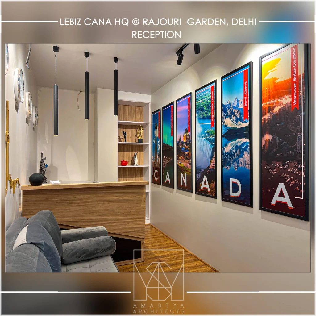 Stylish office reception with framed wall art, wooden flooring and contemporary lighting by interior design companies in Delhi NCR