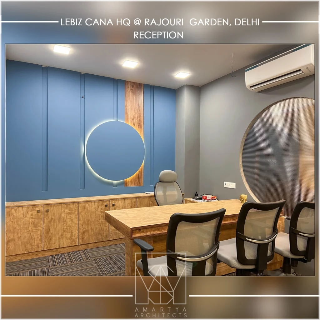 Modern office cabin interior with blue accent wall, wooden furniture and circular design element by commercial interior designers amartya architects.