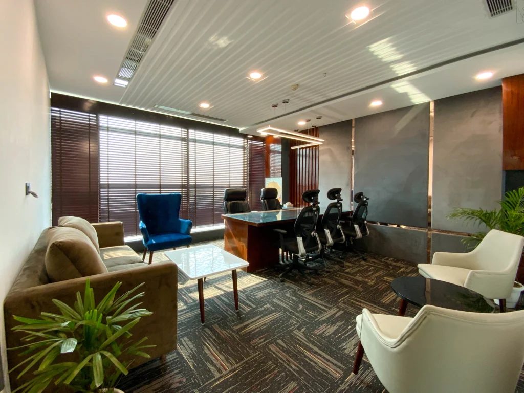 Luxury office cabin interior featuring ergonomic chairs, contemporary lighting, textured wall panels and executive workspace designed by commercial interior architects in Delhi