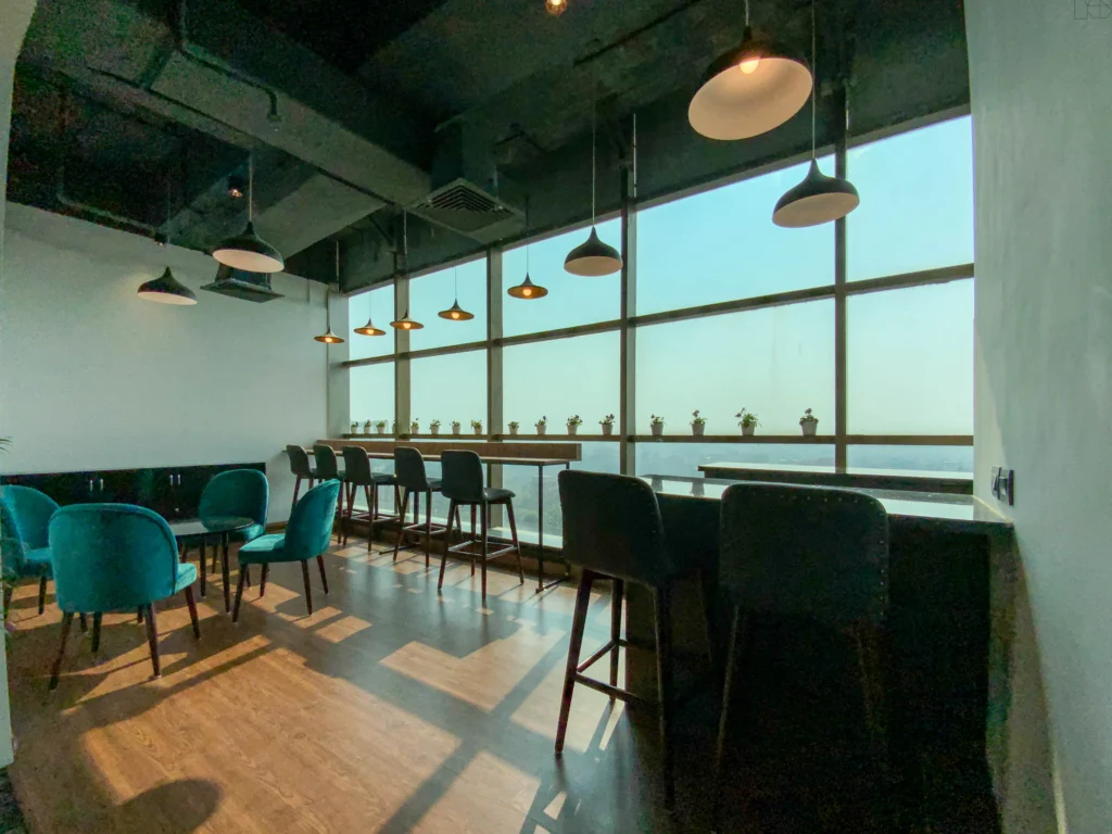 Modern office cafeteria design at Cellcore HQ Rohini with bar seating and city view