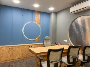 Office meeting room interior design with wooden table and contemporary wall paneling at Lebiz Canada, Rajouri Garden.