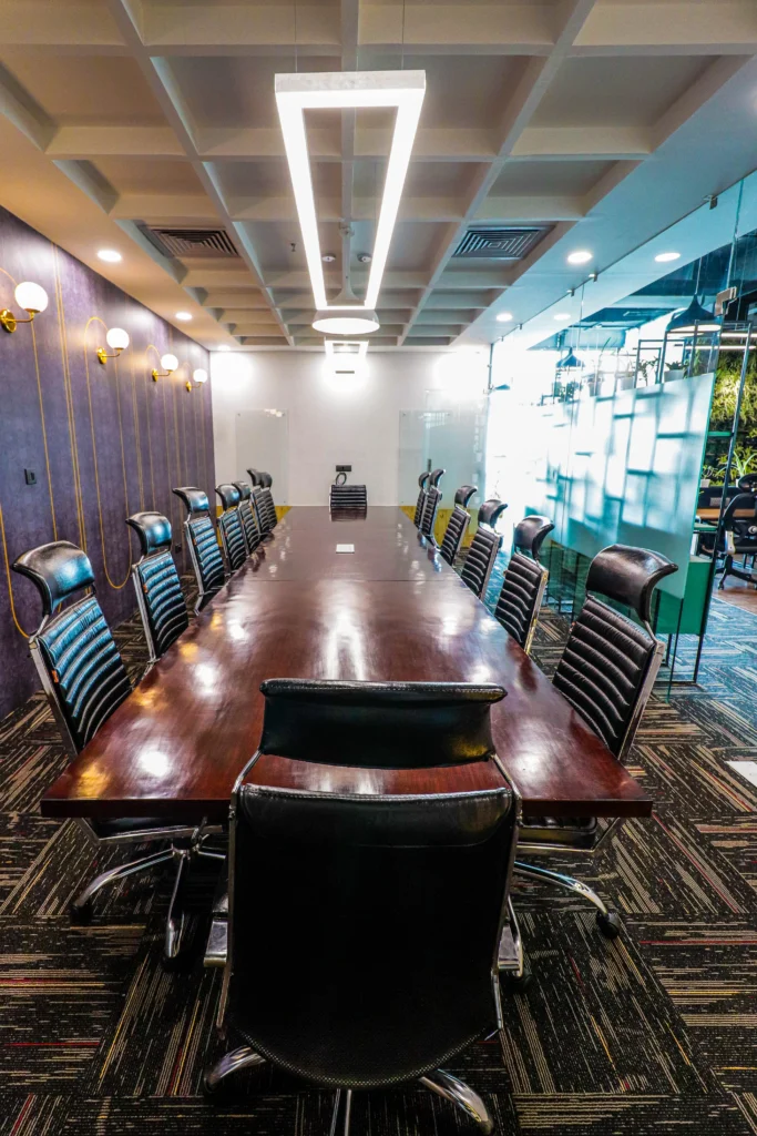 Luxury boardroom design with central conference table, ergonomic office chairs, geometric ceiling lights and premium commercial interior architecture