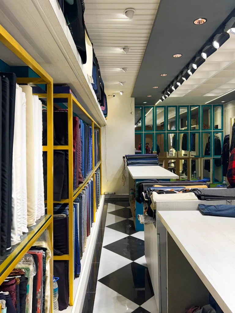 Garment shop interior design with royal theme, arched shelving and premium fabric displays