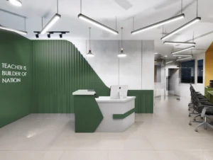 Modern office reception design with green accent wall, custom white reception desk, linear pendant lights and ergonomic workstations by Amartya Architects.