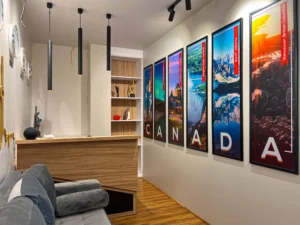 Office reception interior with custom desk, wall art and modern lighting designed by professional interior designers in Delhi NCR.