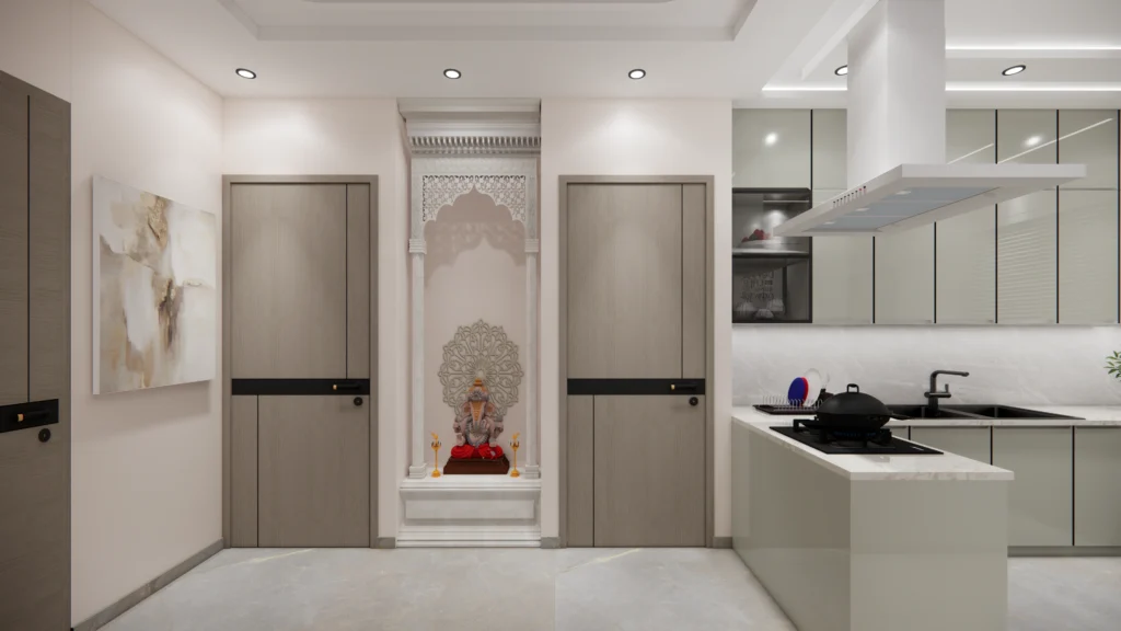 Contemporary home mandir design by Amartya Architects with marble backdrop, carved niche, soft lighting and seamless integration beside modular kitchen.
