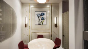 Small meeting room interior with round table, upholstered chairs and artistic wall paneling by Amartya Architects for professional clinics.