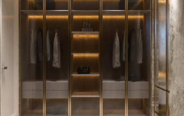 Luxury walk-in wardrobe with glass shutter cabinets, warm LED strip lighting and marble flooring designed by interior designer near me offering walk in wardrobe interior designer near me, home interior design near me and luxury interior designers near me services for premium residences.