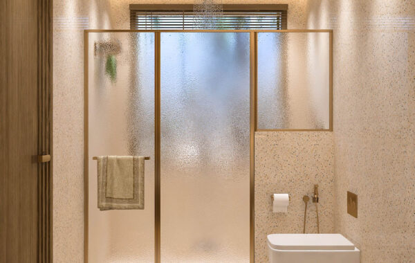 Contemporary small bathroom with frosted glass shower partition, wall-mounted toilet and terrazzo wall finish, designed by bathroom interior designer near me providing affordable interior designers near me, home interior designer near me and modern interior design near me services for residential interiors.